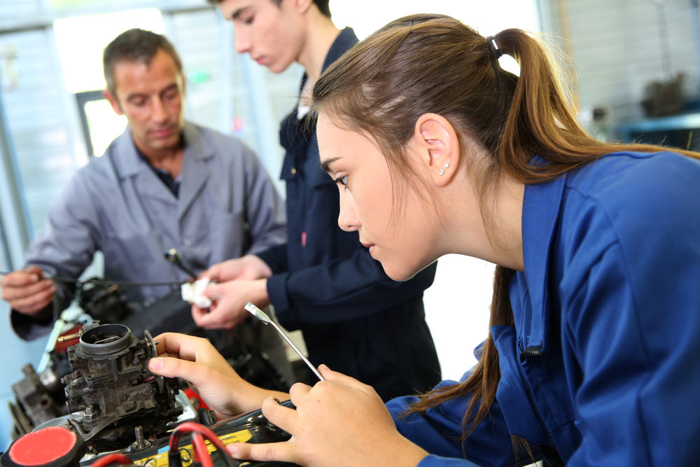 young woman apprentice learning to manufacture