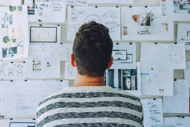 man looking at informative charts on a wall